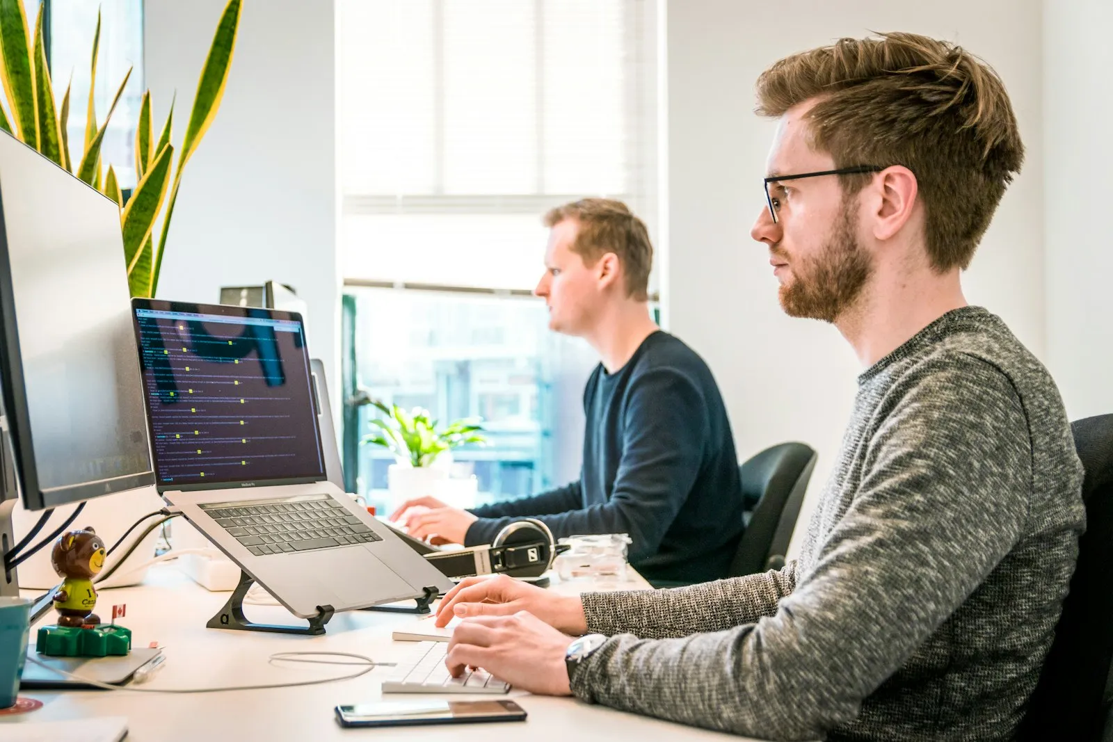 Zwei Personen arbeiten an Stehpulten im modernen Büro